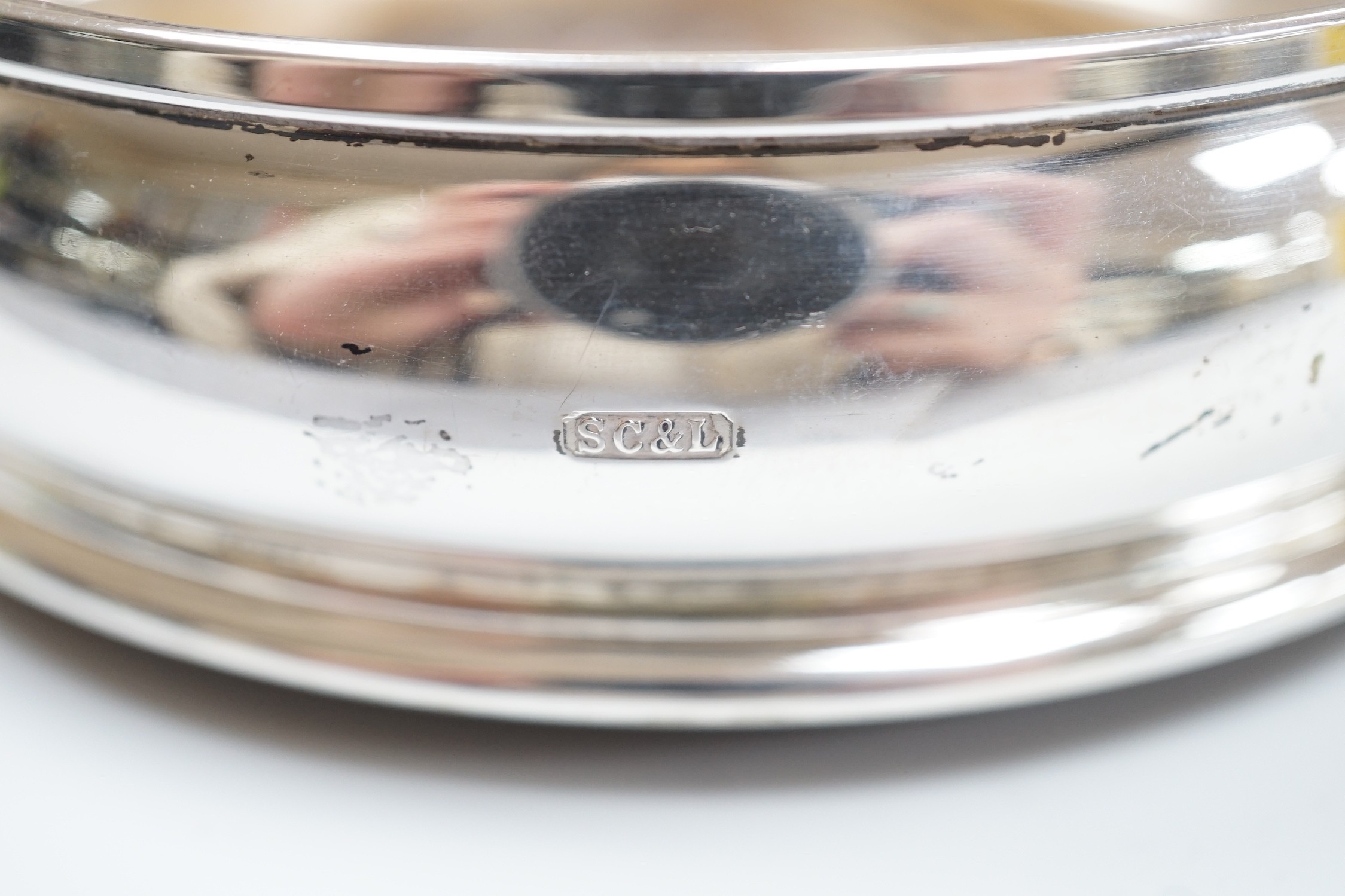 A pair of modern silver wine coasters, diameter 12.4cm and a single silver mounted wine coaster.